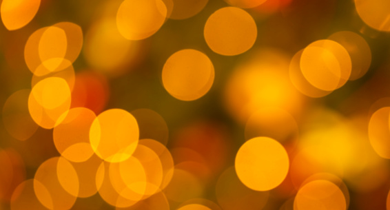 Bright round yellow and orange lights defused for a bokeh background to provide a warm look.
