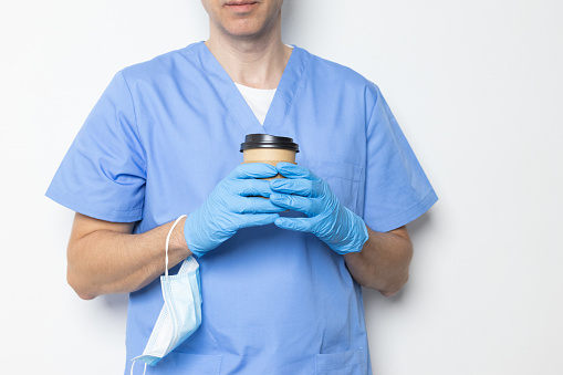 closeup of an unrecognizable doctor taking a coffee break during his shift at the hospital.daily routine of a medical worker.