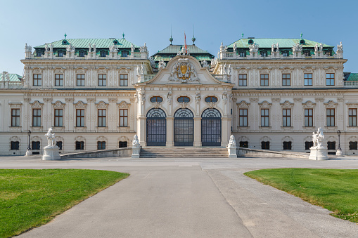 The elegant symmetric gardens and the facade of the Belvedere palace in Vienna, Austria
