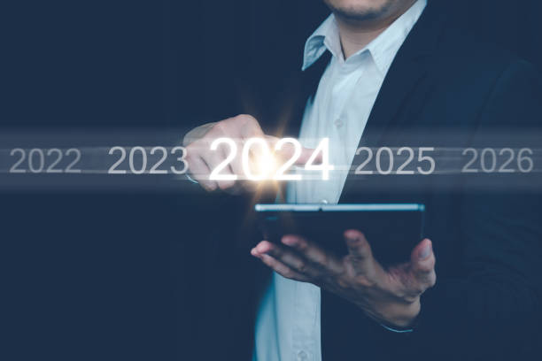 istock Man hand touch on a virtual screen. Future planning new year calendar, Businessman touching future growth year 2023 to 2024, Business strategy. Sort by year. 2010104899