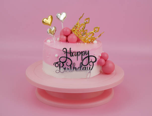 istock Pink birthday cake with gold crown and hearts 2010107866