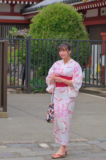 Posing woman in traditional Japanese clothing at the Senso-ji temple area, Photographed in summer Tokyo, Japan, 21_8_2019.