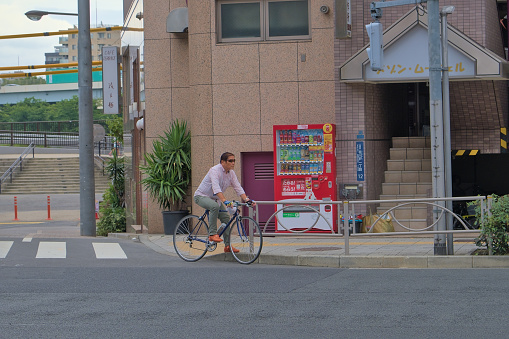 A Japanese urban cyclist with a distinctive style, photographed in summer Tokyo.