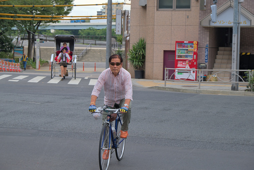 A Japanese urban cyclist with a distinctive style, photographed in summer Tokyo.