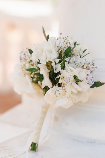Beautiful bouquet of the bride in white with greenery