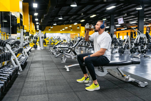 istock Young Man Resting And Drinking A Protein Shake After Training In The Gym 2010128016