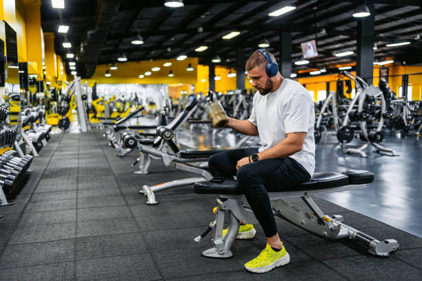 istock Young Man Resting And Drinking A Protein Shake After Training In The Gym 2010132209