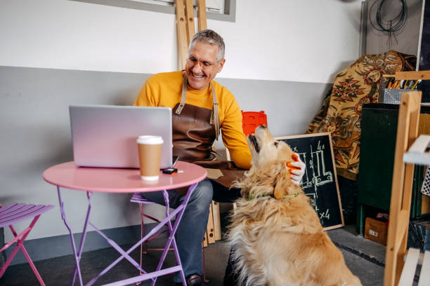 istock Man and his dog spending time together working in garage 2010135074