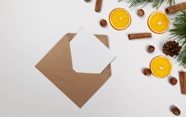 istock Christmas composition, dried orange slices, fir tree branches, cinnamon sticks, pine cones, hazelnuts on white background. 2010150678
