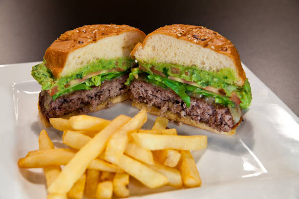 istock Classic American Cheeseburger and Fries on White Plate, Eye-level Perspective 2010151867
