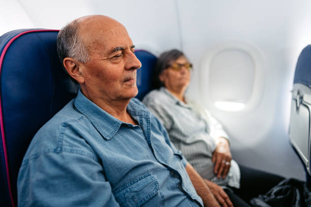 istock Senior Couple Sleeping In An Airplane 2010186024