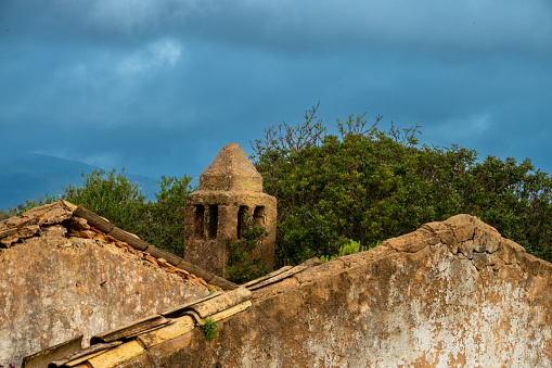 The traditional Algarvian chimney (ChaminÃ© Algarvia) among the ruins of an old farm house, Algarve, Portugal