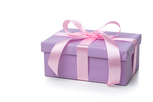 Purple gift box with rose colored ribbon isolated on white background