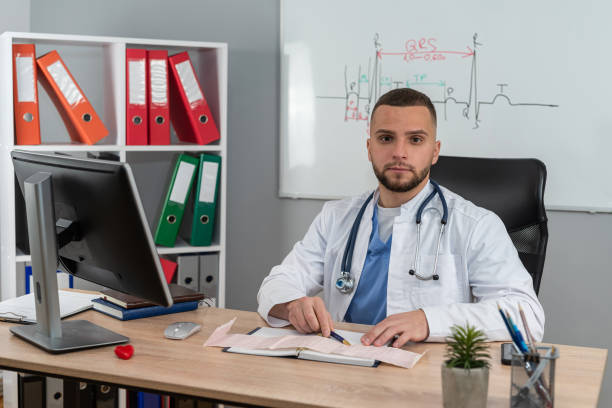 istock Young doctor or e general practitioner physician work in patient files at office medical clinic 2010208153