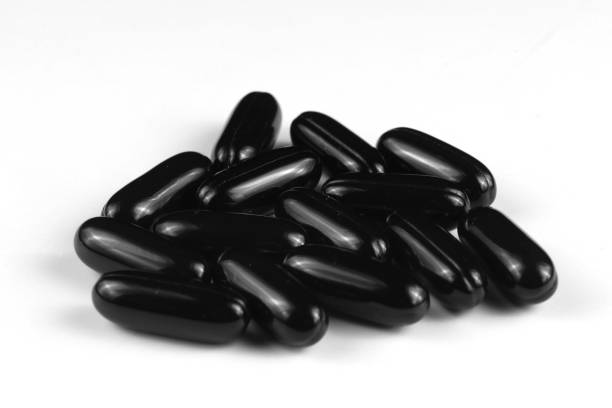 istock Black Gel Capsules Isolated on White 2010220338