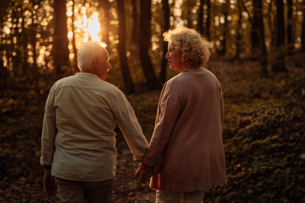 istock Elderly couple holding hands in the woods 2010222427