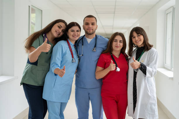 istock Group of happy caucasian intern students in college hallway 2010227905