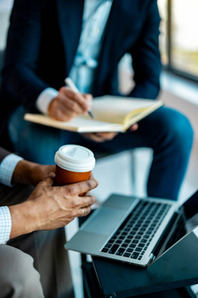 Businessmen working together on a laptop