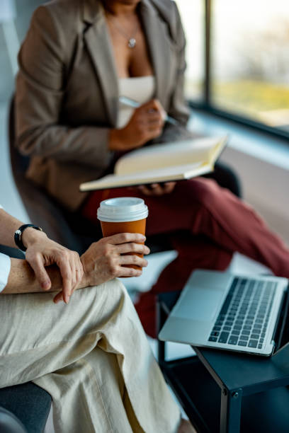 istock Woman holding a clipboard and writing notes while interviewing a candidate for a job 2010236921