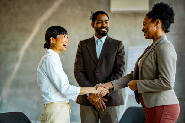 istock Smiling diverse employees handshake at briefing in office 2010238623
