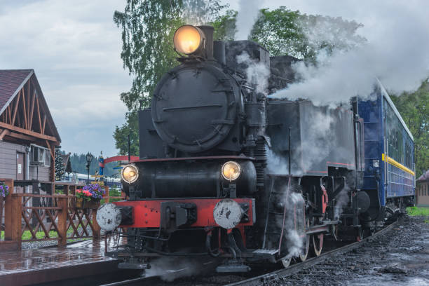 istock Retro steam train arrives to the platform. 2010245144