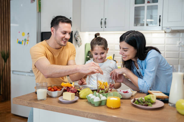 istock Caucasian family, making smoothie for breakfast in the modern kitchen 2010248302