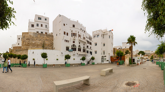 Tangier, Morocco. October 15th, 2022 - Square of Bab Dar Dbagh with buildings constructed on the ancient fortified wall of the medina. In front of the port