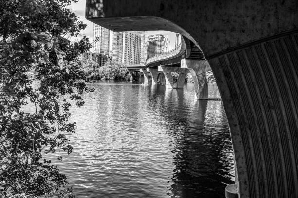 a view from under the pfluger pedestrian bridge on lady bird lake austin texas in black and white - town imagens e fotografias de stock