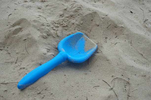 children's sand scoop toy on the beach