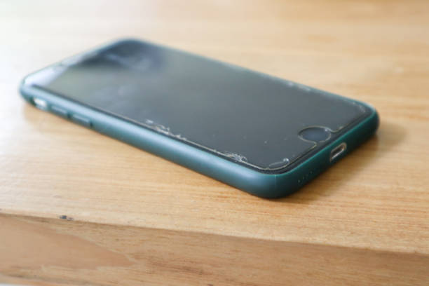 istock a smartphone over a wooden background 2010294787