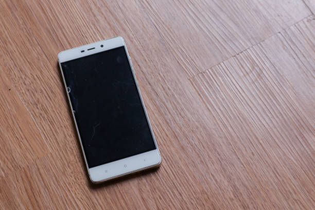 istock a smartphone over a wooden background 2010294788