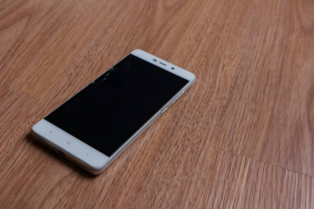 istock a smartphone over a wooden background 2010295873