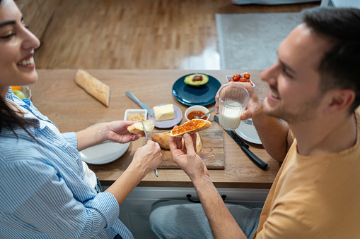 High angle view of an young Caucasian couple, making an breakfast in their modern kitchen