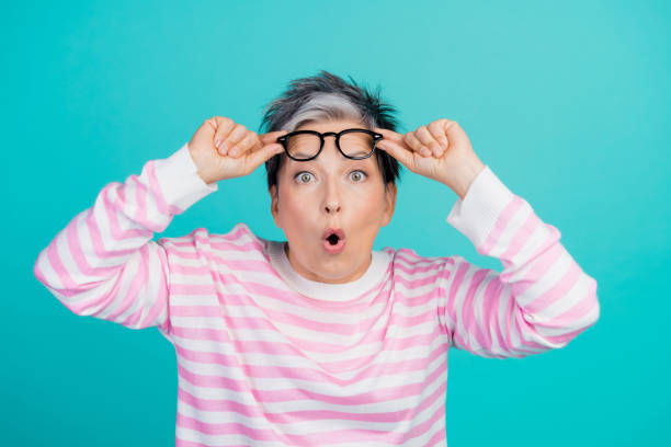 istock Photo of impressed funky woman dressed pink pullover hands arms eyewear empty space isolated teal color background 2010304027