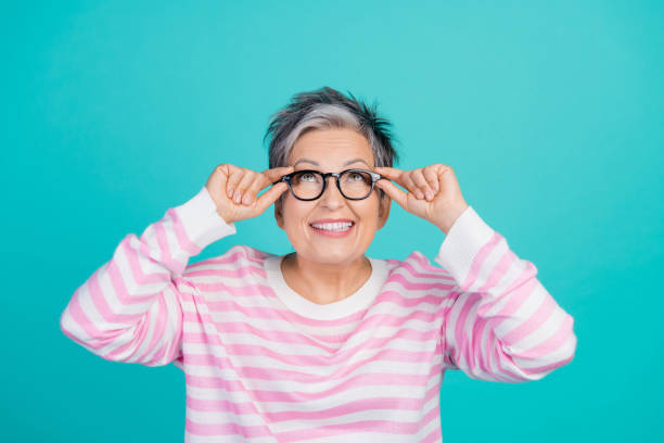 istock Photo of positive funky woman dressed pink pullover hands arms eyewear looking up empty space isolated teal color background 2010304031