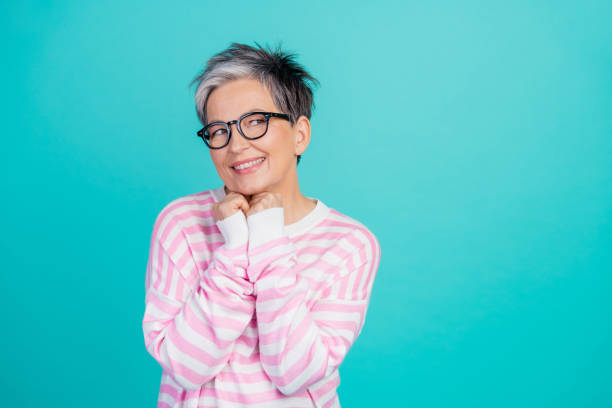 istock Photo of dreamy thoughtful woman dressed pink pullover eyewear looking empty space isolated teal color background 2010304558