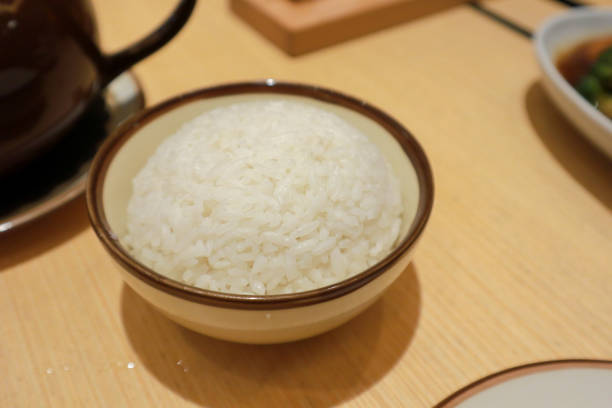 istock White steamed rice in round bowl 2010316668