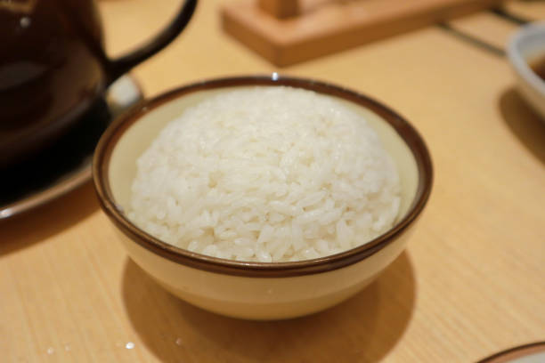 istock White steamed rice in round bowl 2010316672