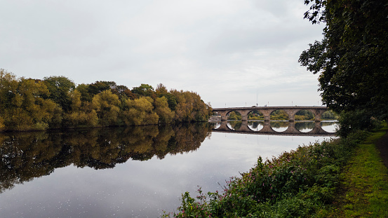 Scenic river with a bridge stretching over the water in Hexham, Nort East England.