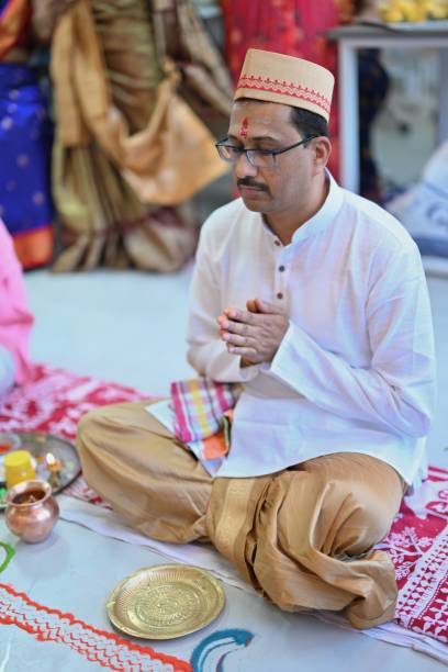 istock Mid adult Indian man sits with hands folded and praying while performing pooja 2010339602