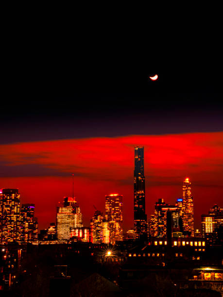 Moody New York City Skyline at moonrise, over Brooklyn Rooftops
