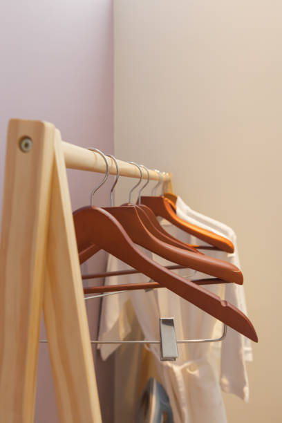 istock Group of empty wooden hanger on the rod 2010349197