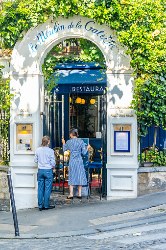 Paris, France - September 10, 2023 : Entrance of Moulin de la Galette restaurant in the district of Montmartre in Paris, France