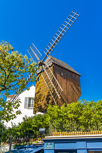 Paris, France - September 10, 2023 : Close up of the windmill of Moulin de la Galette in Montmartre in Paris, France