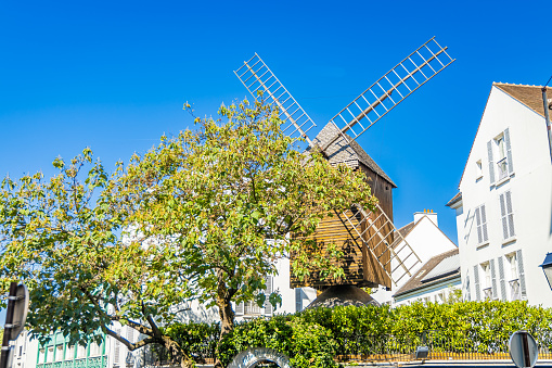 Paris, France - September 10, 2023 : Panoramic view of the Moulin de la Galette, a windmill situated near the top of the district of Montmartre in Paris, France