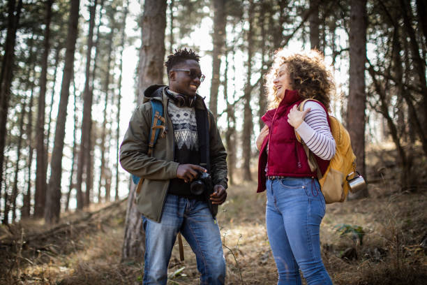 istock Millennial couple hiking through the forest, talking and smiling together. 2010362344