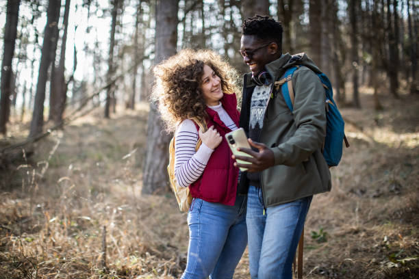 istock Smiling young couple hiking through the forest and making a selfie. 2010362907