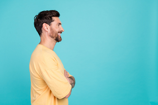Side profile photo of confident man brunet hair model posing his trendy haircut in barbershop isolated on aquamarine color background.