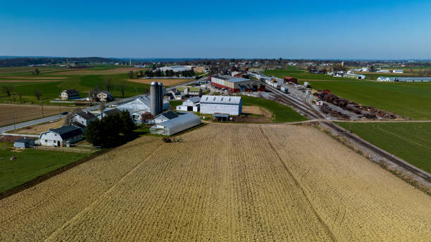 istock Aerial View Of A Farm Complex With Multiple Barns, Silos, And Plowed Fields In A Rural Setting 2010401013