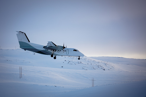 Aircraft approaching the airport with winter landscape.